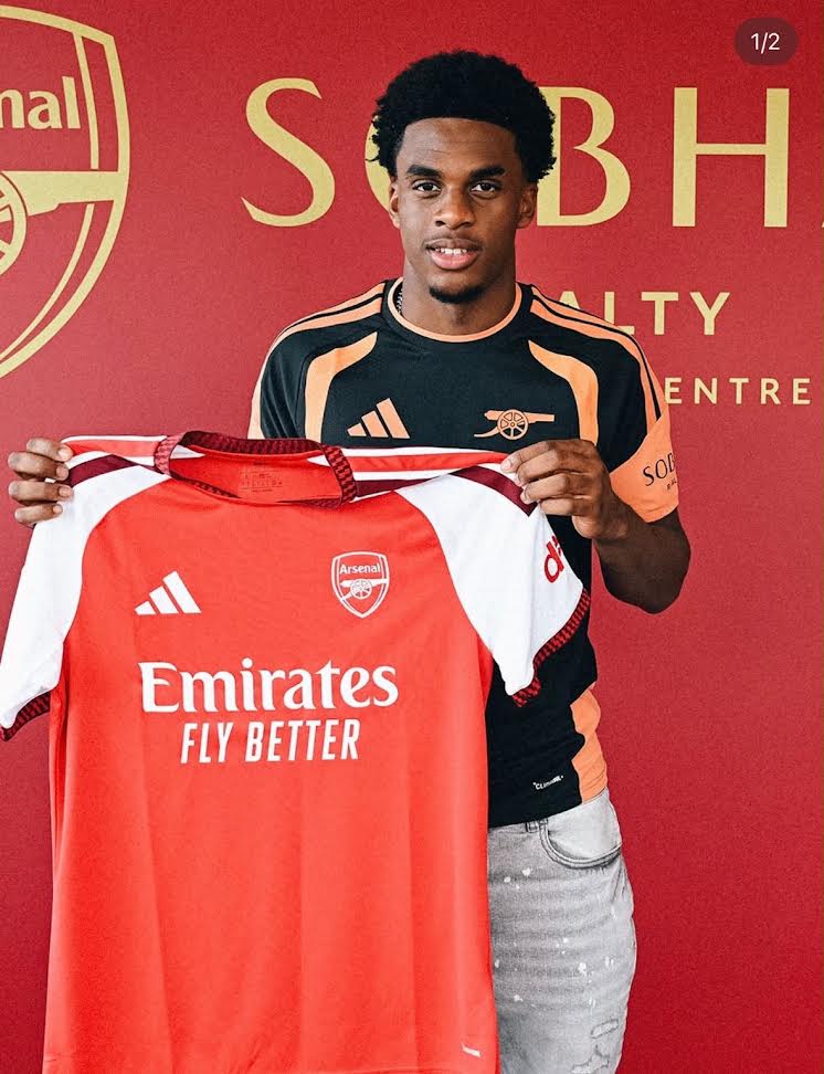 Client holding an Arsenal shirt