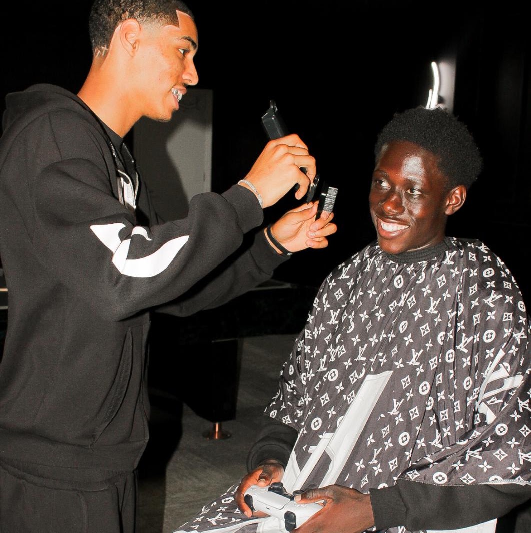 Frenchie cutting a client's hair during a home visit